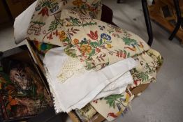A selection of retro textiles and fabrics including patchwork cushion and table cloths etc