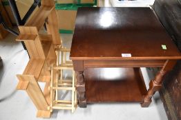 A modern side table with wall shelf and wine rack