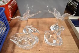 A pair of art glass swans and two similar swan design glass works