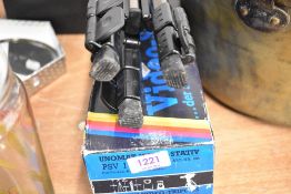 A Video recorder tripod in box.
