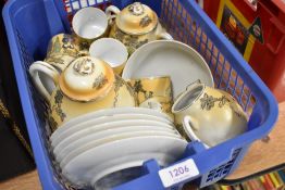 A Japanese part tea service being eggshell with hand decorated geisha scenes