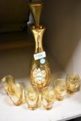 A Venetian amber glass decanter set with floral and gilt decoration