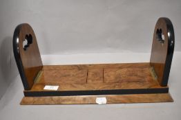 A Victorian book slide, walnut with decorative brass motifs to ends (one area loose but present) one