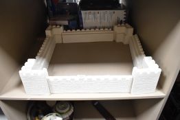 A mock plaster castle chess board stand