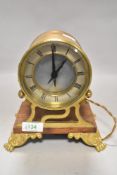 An Edwardian barrel or port hole style clock in heavy ormolu case on lions paw feet by Smiths