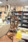 Victorian spinning wheel having turned oak and mahogany frame