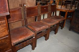 A set of four period oak and leather chairs with brass stud work