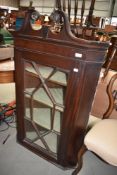 A 19th Century corner unit having astral glazed door and mahogany carcass