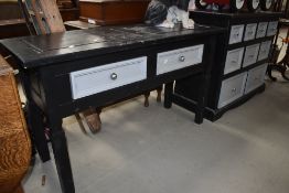 A 20th century storage chest and matching desk painted black and gray