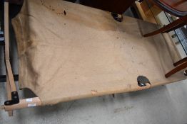 A 20th century military or camping fold away bed