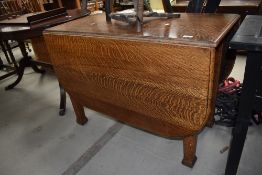A 20th century oak drop leaf dining table