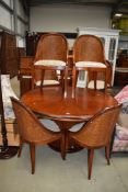 A 20th century Art Deco design extending circular pedestal table and rattan chair set of six