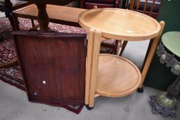 A modern light wood tea trolley and mahogany tray