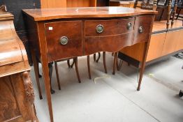 An early 20th Century Regency revival mahogany serpentine fronted sideboard on square tapered legs
