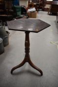 A Victorian mahogany octagonal wine table having turned tripod base