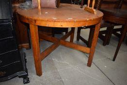 A vintage red stain oak circular dining table