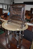 An Indian campaign table with brass top and a Chinese privacy screen hand carved with double dragon