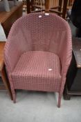 An Art Deco Lloyd Loom Lusty tub chair in pink
