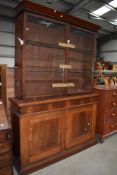 A Victorian substantial library book case and cupboard in mahogany with drawer and under cupboard