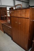 A mid century G Plan bedroom chest of three drawers and matching low wardrobe