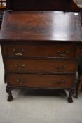 A reproduction mahogany bureau