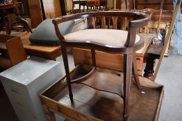 An Edwardian mahogany rail back dressing table stool