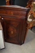 A 19th Century mahogany corner cupbpard having shell design inlay decoration