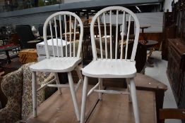 A pair of traditional painted hoop and stick back kitchen chairs