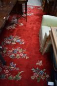 A Chinese carpet square having red ground and foliate and boat decoration , approx. 360 x 250cm