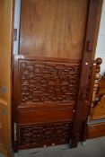 An Oriental hardwood single bed