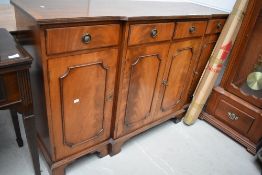 A reproduction Regency style breakfront sideboard