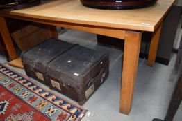 A large modern pine dining table, of shaped rectangular form with end extensions, and raised on