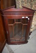 A reproduction mahogany corner wall display