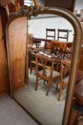 An early Victorian hall way or dress mirror having gilt and gesso frame with ribbon work