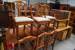 Four classically styled modern pine dining chairs and two carvers, having cut out detailing to backs