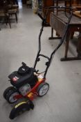 A petrol driven lawn edger , having Briggs and Stratton engine, model MTD 550G