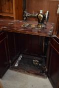 A late 19th or early 20th Century Jones sewing machine in mahogany cabinet
