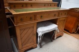 A Victorian golden oak desk, in the Aesthetic style