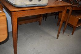 A mid century oak extending dining table, of plain rectangular form with tapering square legs