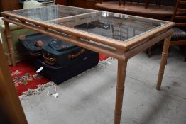 A large wood and glass dining table, approx 180 x 90cm