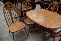 A set of four modern light elm Ercol kicthen dining chairs having swan backs