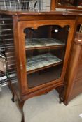 A 19th Century mahogany display or music cabinet having lined shelves and inlaid decoration