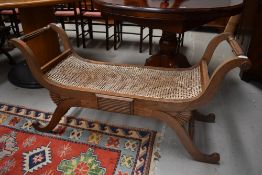 A bleached mahogany bergere seated love seat in the Regency style