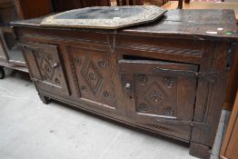 A Period oak kist having carved panel door fronts