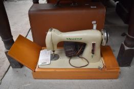 A vintage Swiss made Helvetia sewing machine with case.