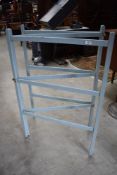 An early 20th century painted pine fold out towel rail