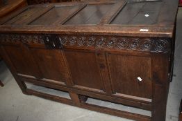 A period oak kist having four panelled lid and front, dummy drawer fronts from base included