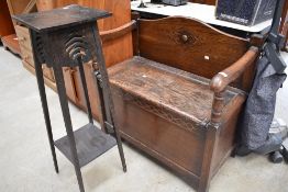 An early 20th Century dark oak box settle and stained frame jardiniere stand