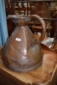 A vintage copper jug of large proportions