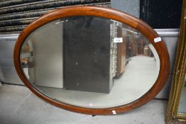 An early 20th century mahogany oval wall mirror
